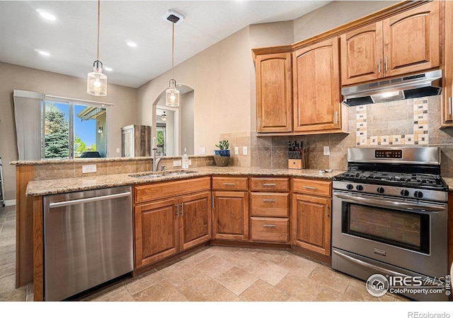 4609 Freehold Dr, Windsor, CO 80550 - kitchen featuring appliances with stainless steel finishes, under cabinet range hood, a peninsula, tasteful backsplash, and arched walkways