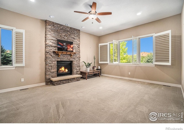 4609 Freehold Dr, Windsor, CO 80550 - unfurnished living room with carpet floors, a ceiling fan, a stone fireplace, and recessed lighting