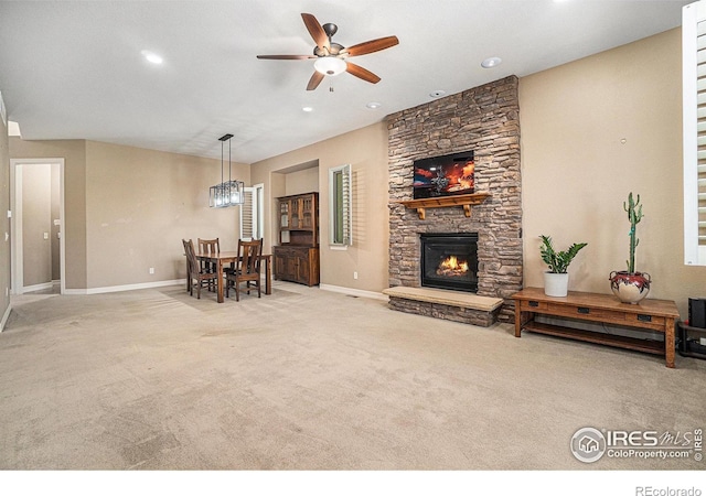 4609 Freehold Dr, Windsor, CO 80550 - carpeted living room with a ceiling fan, a stone fireplace, and recessed lighting