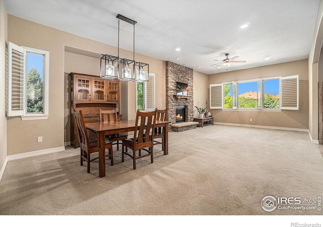 4609 Freehold Dr, Windsor, CO 80550 - dining room featuring a fireplace, carpet, a ceiling fan, and recessed lighting
