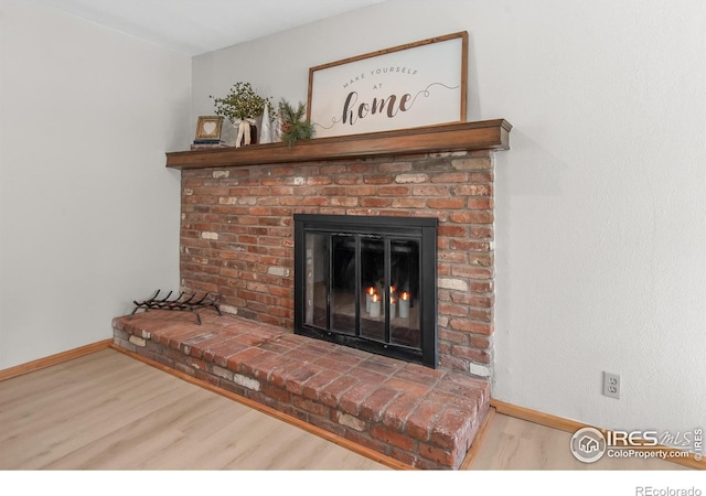 4888 Silver Spruce Ln, Evergreen, CO 80439 - detailed view of wood finished floors, baseboards, and a fireplace