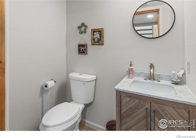 4888 Silver Spruce Ln, Evergreen, CO 80439 - half bathroom with toilet, vanity, and baseboards