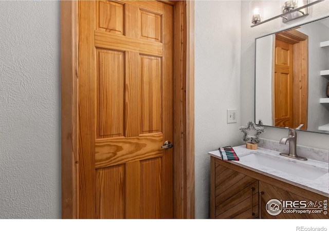 4888 Silver Spruce Ln, Evergreen, CO 80439 - bathroom with vanity and a textured wall