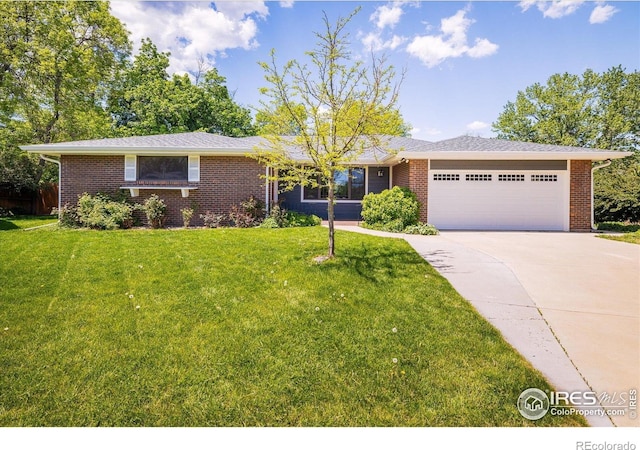 4760 Lee Cir, Boulder, CO 80303 - view of front of house with a garage, driveway, a front lawn, and brick siding