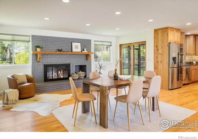 4760 Lee Cir, Boulder, CO 80303 - dining space featuring a fireplace, light wood-style floors, and recessed lighting