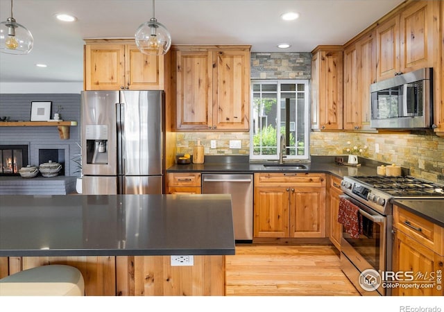 4760 Lee Cir, Boulder, CO 80303 - kitchen with appliances with stainless steel finishes, a sink, dark countertops, decorative backsplash, and recessed lighting