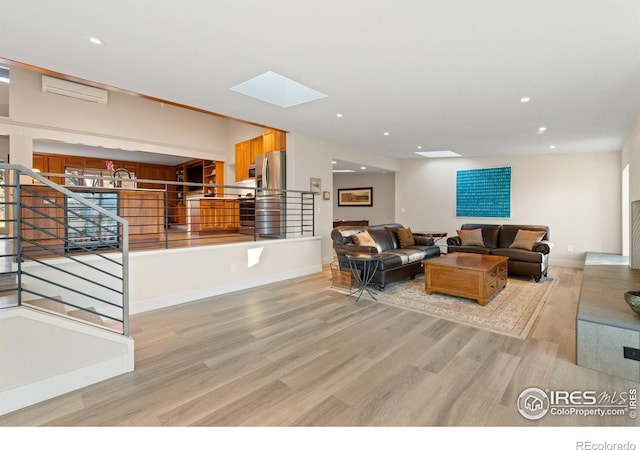 819 Gapter Rd, Boulder, CO 80303 - living room with a wall mounted AC, light wood-style flooring, recessed lighting, a skylight, and stairway