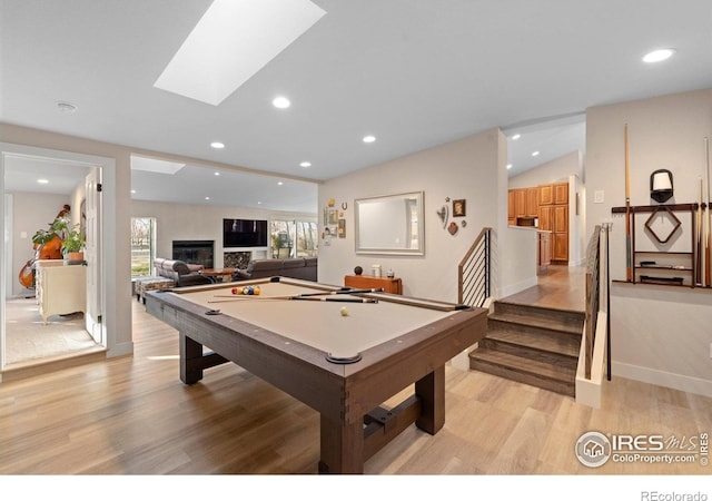 819 Gapter Rd, Boulder, CO 80303 - recreation room featuring light wood-style floors, billiards, a glass covered fireplace, recessed lighting, and vaulted ceiling