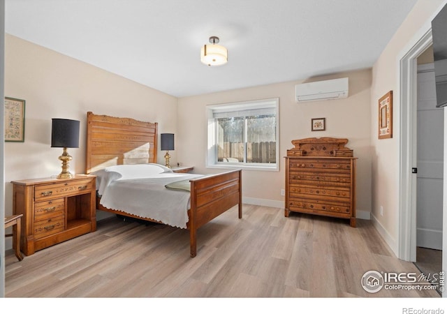 819 Gapter Rd, Boulder, CO 80303 - bedroom with a wall mounted AC, light wood-type flooring, and baseboards