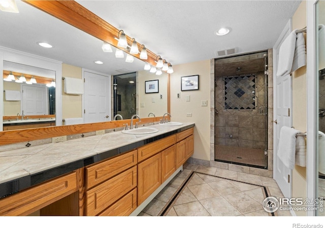 819 Gapter Rd, Boulder, CO 80303 - full bathroom with a shower stall, inlaid floor details, tile patterned floors, double vanity, and recessed lighting