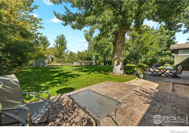 819 Gapter Rd, Boulder, CO 80303 - view of patio / terrace featuring outdoor dining area, an outbuilding, and a storage shed
