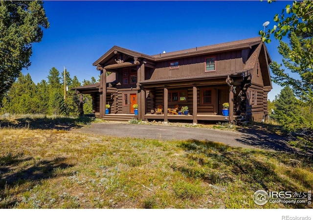 351 County Road 128n, Nederland, CO 80466 - back of property with log exterior, covered porch, and board and batten siding