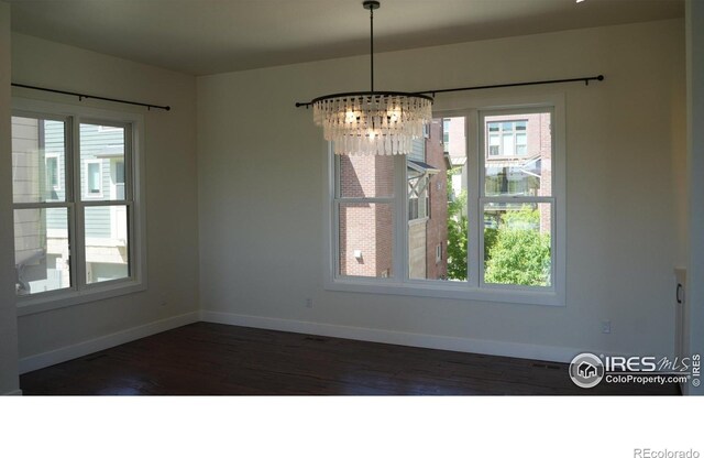 410 Superior Dr, Superior, CO 80027 - unfurnished dining area featuring a chandelier, baseboards, and dark wood-type flooring