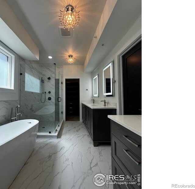 410 Superior Dr, Superior, CO 80027 - full bathroom featuring a shower stall, marble finish flooring, vanity, a soaking tub, and recessed lighting