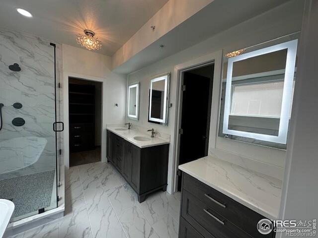 410 Superior Dr, Superior, CO 80027 - bathroom with a marble finish shower, marble finish flooring, and vanity