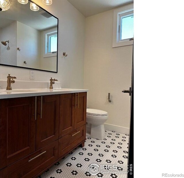410 Superior Dr, Superior, CO 80027 - bathroom with toilet, baseboards, vanity, and tile patterned floors