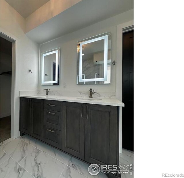 410 Superior Dr, Superior, CO 80027 - bathroom featuring double vanity and marble finish flooring