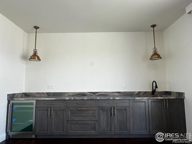 410 Superior Dr, Superior, CO 80027 - indoor bar with wine cooler, hanging light fixtures, and dark wood-style floors