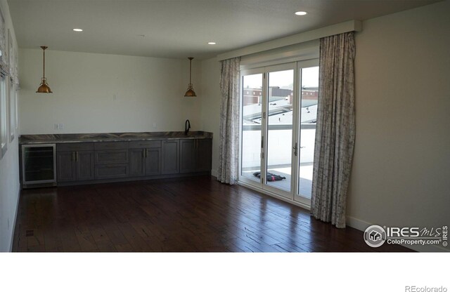410 Superior Dr, Superior, CO 80027 - unfurnished room with beverage cooler, dark wood-style flooring, recessed lighting, and a sink