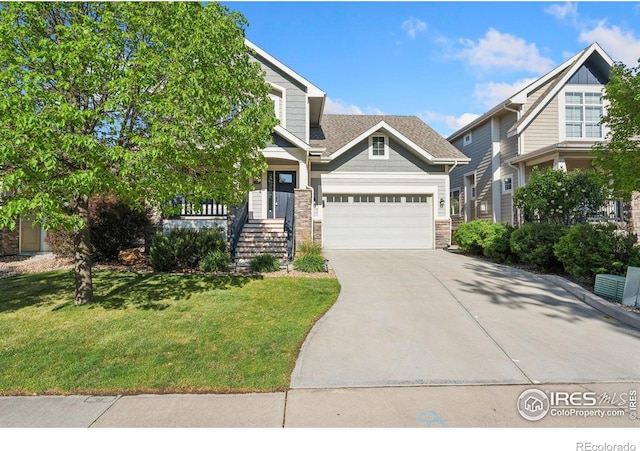 4045 Stoney Creek Dr, Fort Collins, CO 80525 - view of front of home with driveway, a front lawn, stone siding, and a garage