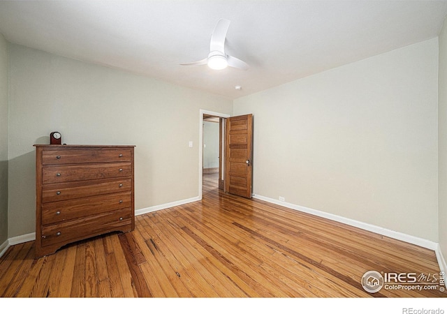 bedroom with hardwood / wood-style floors, baseboards, and a ceiling fan