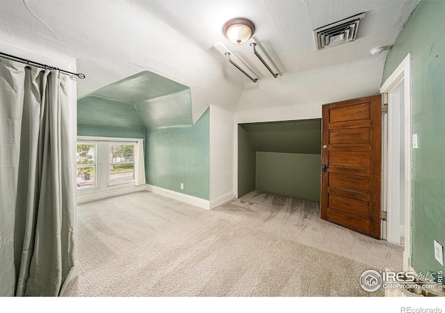 additional living space with carpet flooring, vaulted ceiling, and baseboards