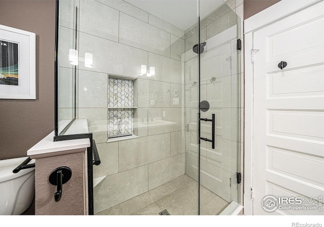 full bath with a stall shower and toilet