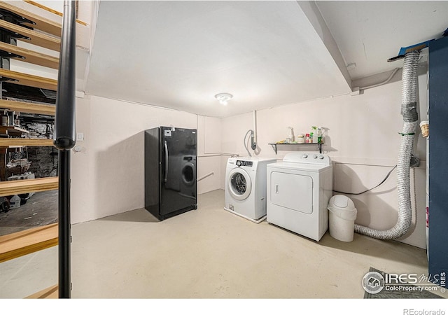 clothes washing area featuring separate washer and dryer