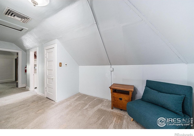 living area featuring carpet flooring and lofted ceiling