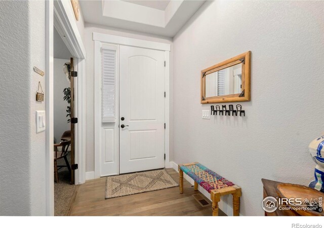 entryway featuring wood finished floors and baseboards