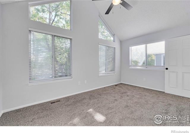 12525 E Tennessee Cir Unit E, Aurora, CO 80012 - empty room with a ceiling fan, carpet flooring, high vaulted ceiling, baseboards, and a textured ceiling