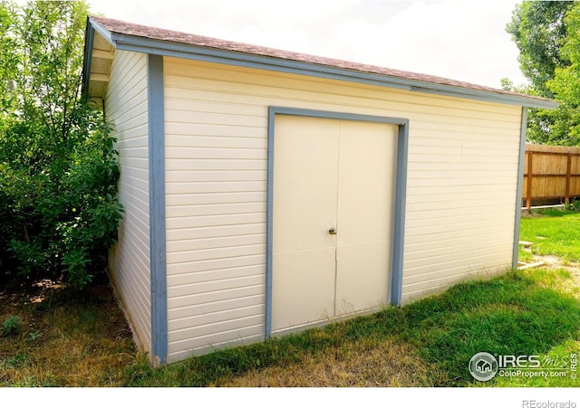 view of shed featuring fence