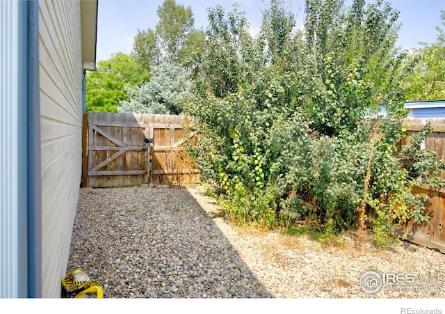 fenced backyard featuring a gate