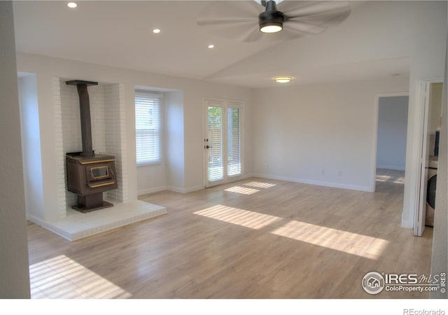 unfurnished living room with lofted ceiling, a ceiling fan, light wood-type flooring, baseboards, and recessed lighting