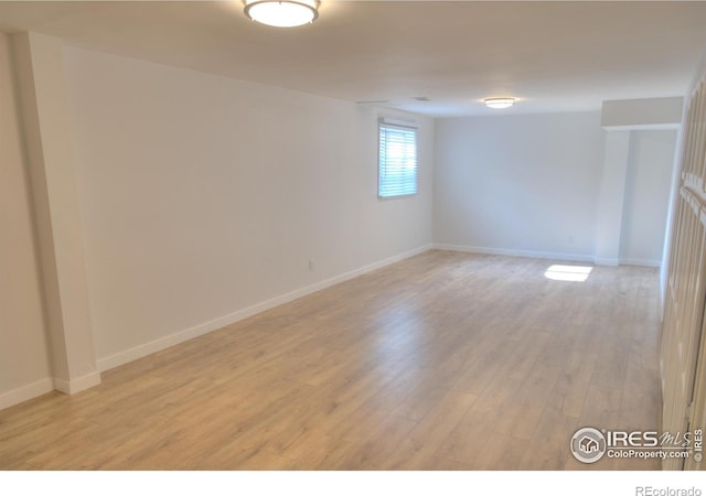 unfurnished room featuring light wood-style flooring and baseboards