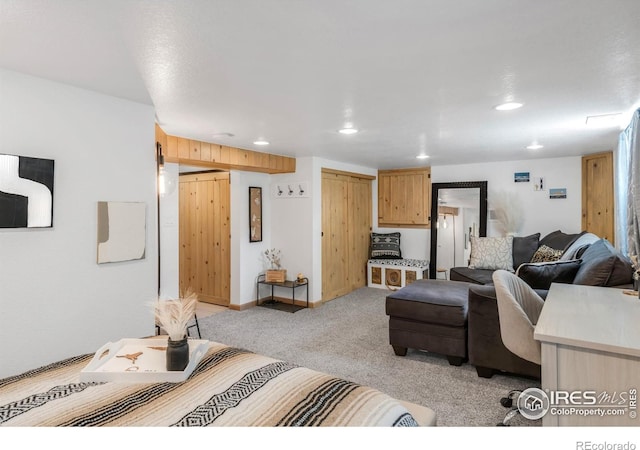 living area with light colored carpet and recessed lighting