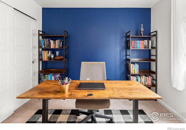home office featuring carpet and baseboards
