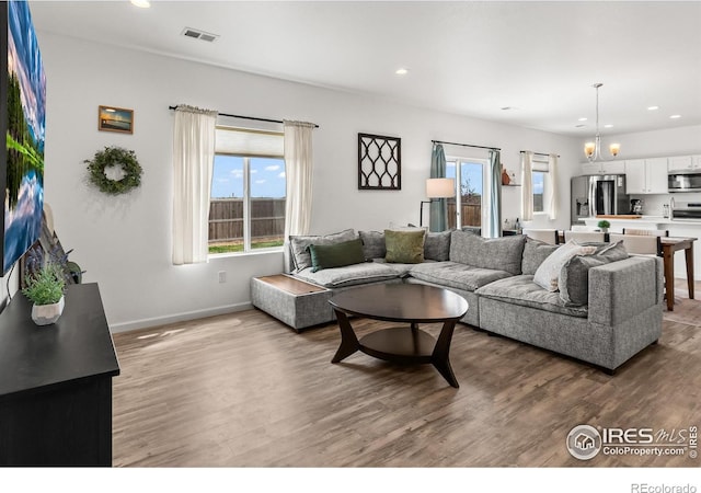 1246 Sherman Dr, Dacono, CO 80514 - living room featuring recessed lighting, wood finished floors, and baseboards
