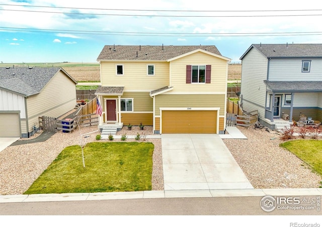 1246 Sherman Dr, Dacono, CO 80514 - view of front of property with concrete driveway and an attached garage