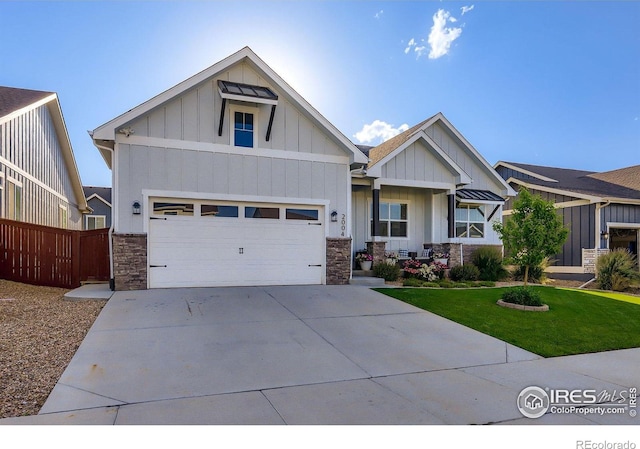 2004 Day Spring Dr, Windsor, CO 80550 - craftsman-style home with board and batten siding, stone siding, concrete driveway, and a garage
