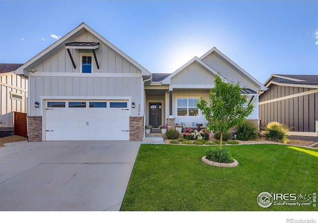 2004 Day Spring Dr, Windsor, CO 80550 - craftsman house with stone siding, board and batten siding, concrete driveway, and a front yard