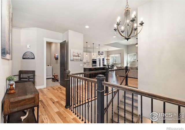 2004 Day Spring Dr, Windsor, CO 80550 - hallway with an upstairs landing, a chandelier, light wood finished floors, and recessed lighting