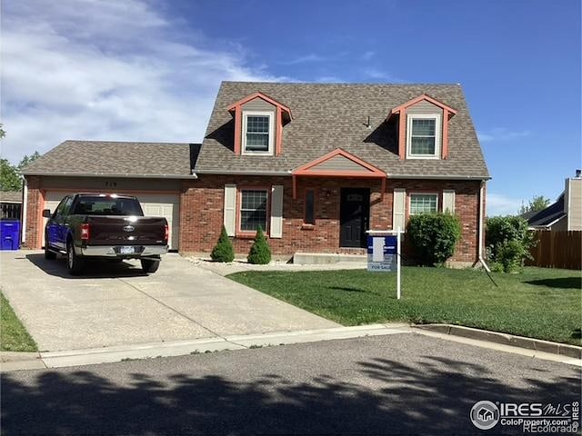 719 Marshall Pl, Berthoud, CO 80513 - cape cod-style house with concrete driveway, a front yard, brick siding, and an attached garage