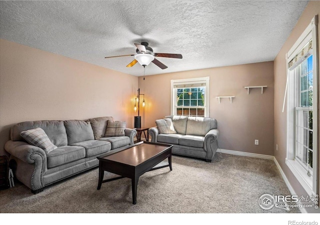 719 Marshall Pl, Berthoud, CO 80513 - carpeted living area featuring a ceiling fan, healthy amount of natural light, baseboards, and a textured ceiling