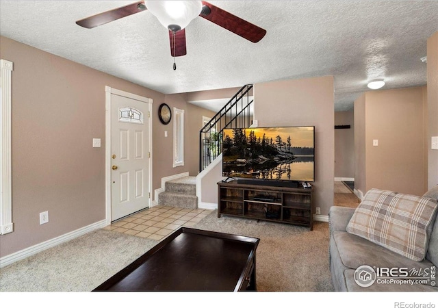 719 Marshall Pl, Berthoud, CO 80513 - living room featuring a textured ceiling, stairs, ceiling fan, baseboards, and carpet
