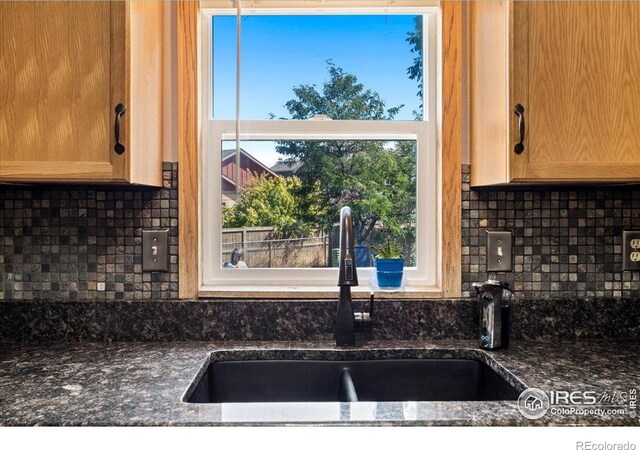719 Marshall Pl, Berthoud, CO 80513 - kitchen with a sink, tasteful backsplash, dark stone countertops, and plenty of natural light