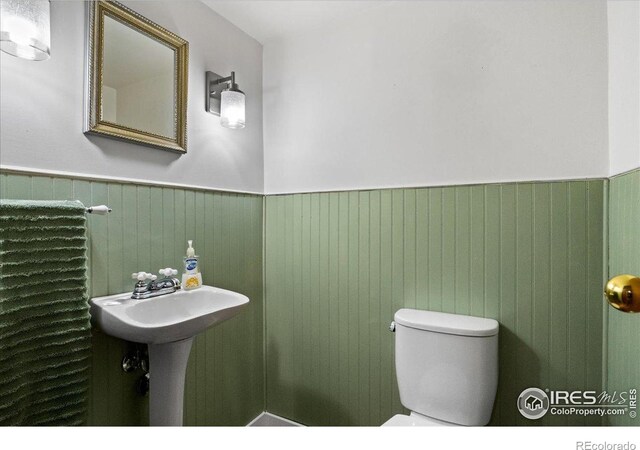 719 Marshall Pl, Berthoud, CO 80513 - half bathroom with a wainscoted wall and toilet