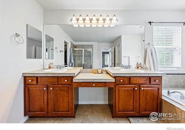 full bath featuring a shower stall, a bath, and two vanities