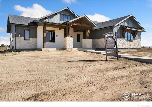 951 Warbling Dr, Windsor, CO 80550 - view of front of property featuring stone siding, board and batten siding, and a shingled roof