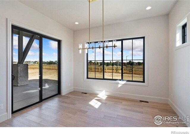 951 Warbling Dr, Windsor, CO 80550 - unfurnished dining area featuring wood finished floors, baseboards, and recessed lighting
